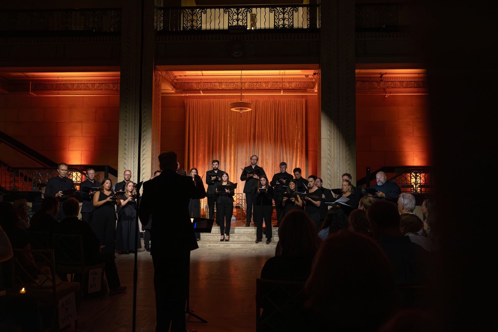 Re:Sound Ensembles performing on stage with warm orange curtains